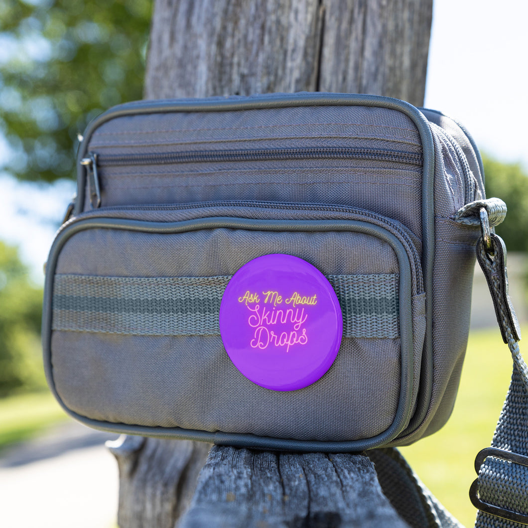 Partner.Co | Ask Me About Skinny Drops Neon Logo Purple | Button Pins